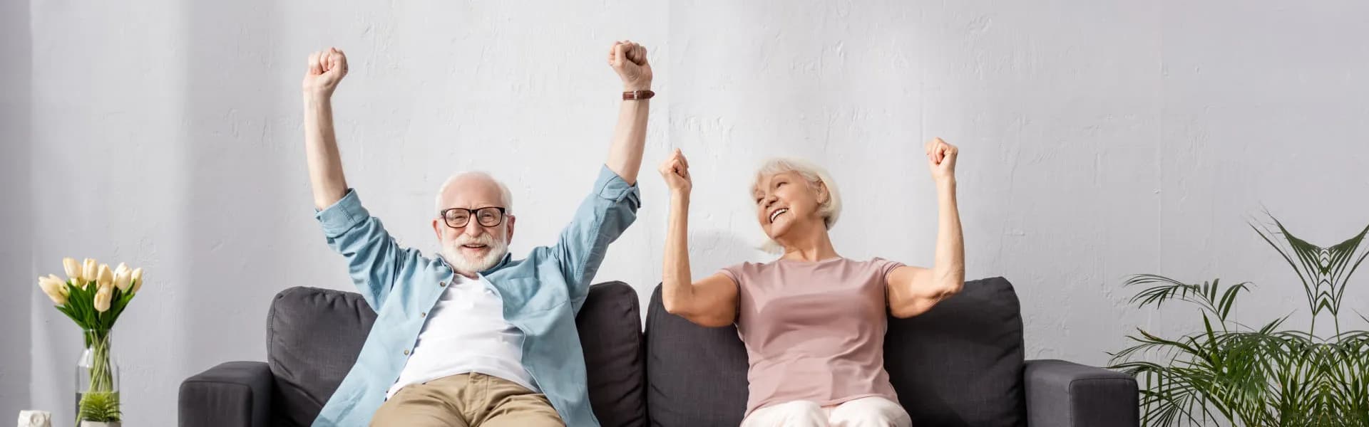 Happy elderly couple reviewing senior care resources together - Hero Slide 1